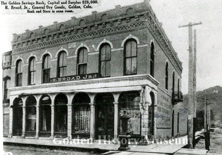 2 story commercial building with sign saying "R. Broad Jr."