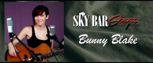 Bunny Blake (woman with short dark hair holding guitar) at the Sky Bar Stage, Buffalo Rose