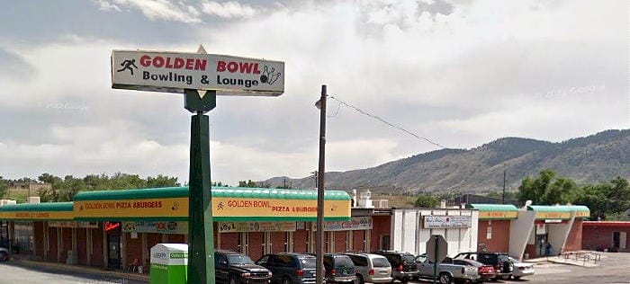 large one-story brick building with signs saying Golden Bowl