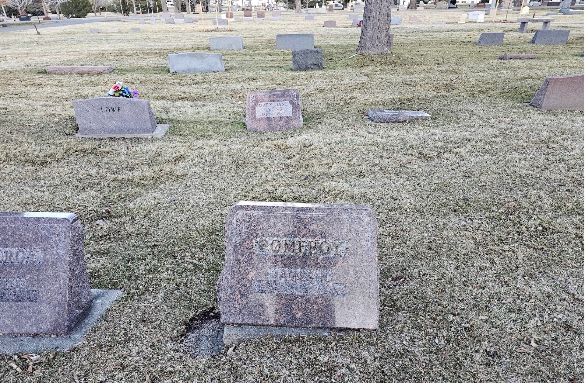 Red granite headstone with POMEROY engraved.  Other gravestones visible in the area.