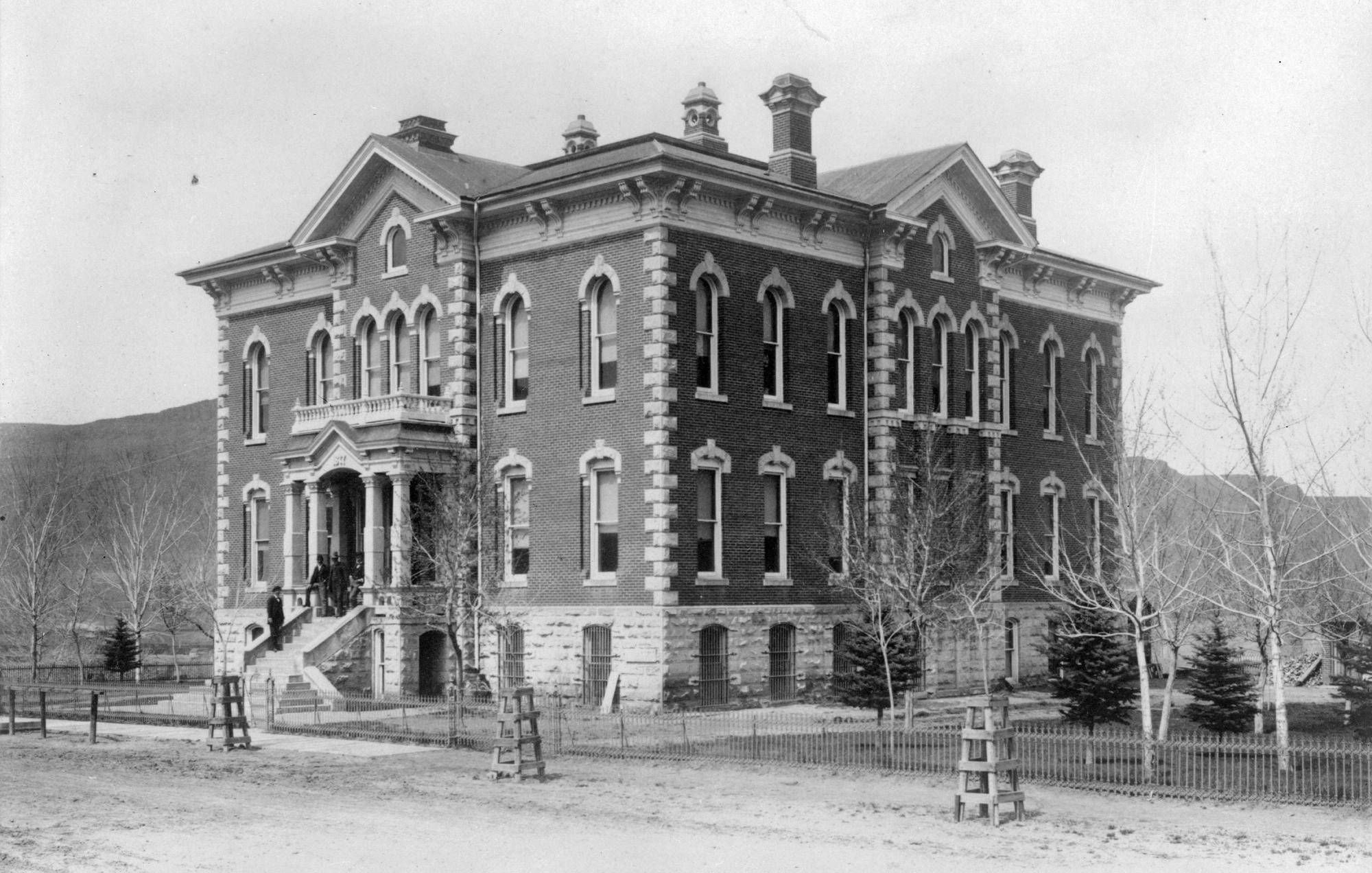 Photograph of the Jefferson County Courthouse, which opened in 1878.  It is surrounded by saplings.