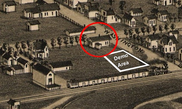 Sepia-toned hand-drawn map shows a steam locomotive passing through an area with one and two story buildings