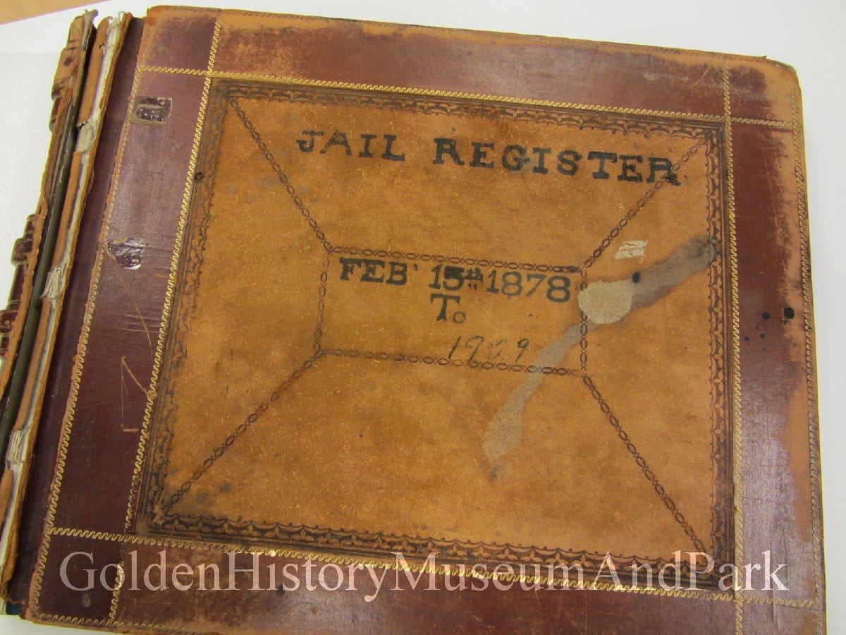 large brown leather binder with cover saying "JAIL REGISTER - FEB 15th 1878 To 1929"