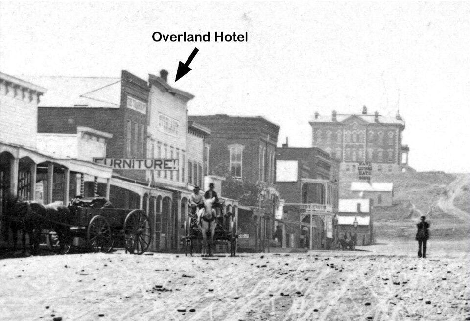 black and white photo of pioneer-era buildings on Golden's Washington Avenue.  The 1878 county courthouse appears at top of hill.