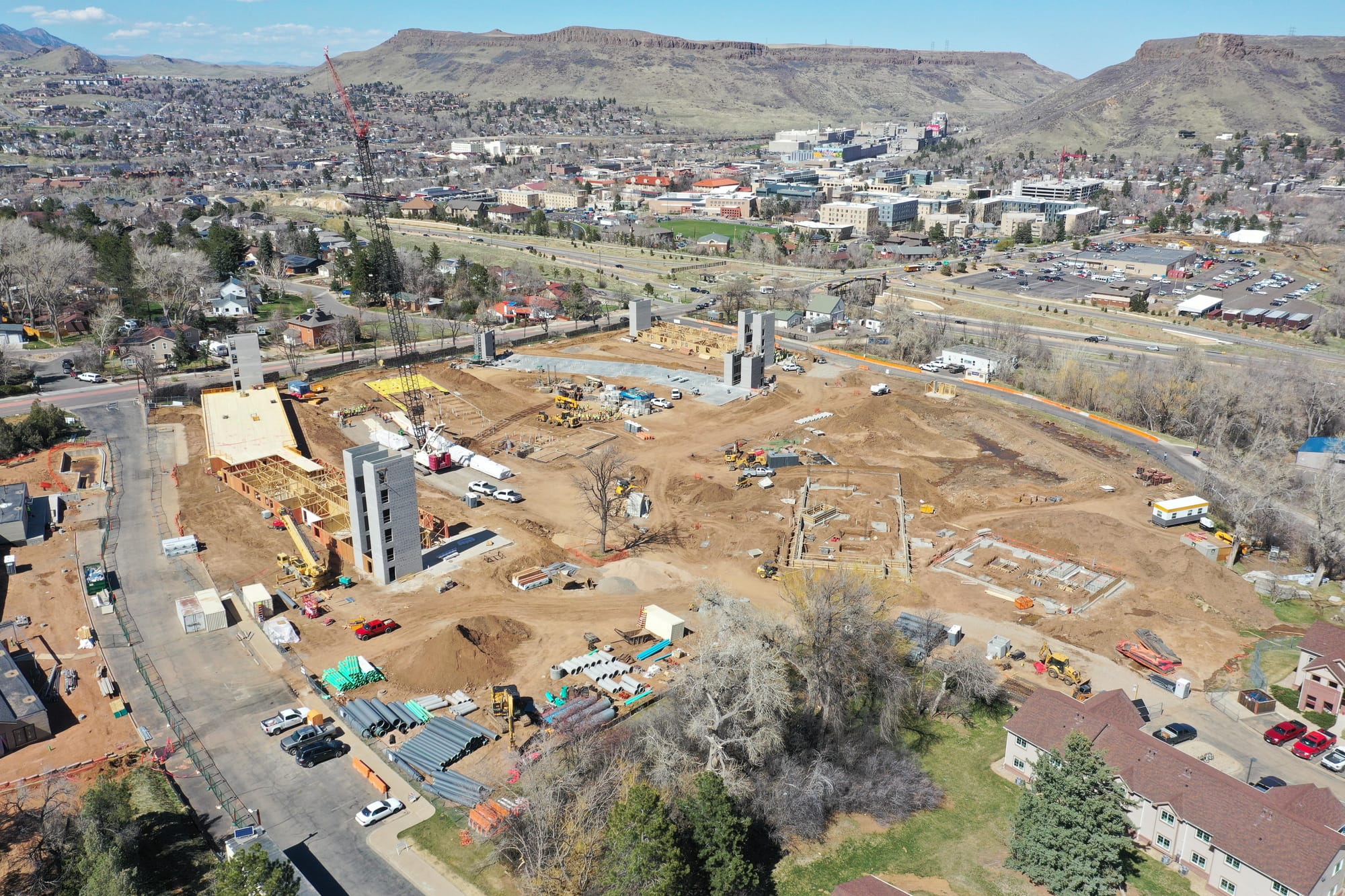 construction site with several concrete structures promising future 6-floor elevator shafts - Table Mountains in background