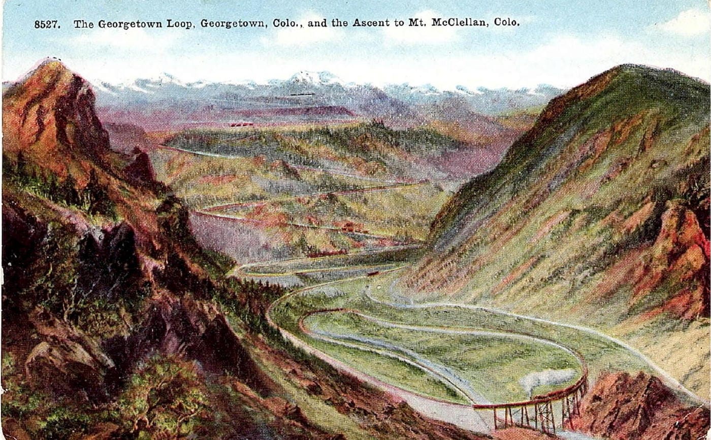 Hand-tinted postcard shows the looping railroad with a steam locomotive crossing a very tall bridge.