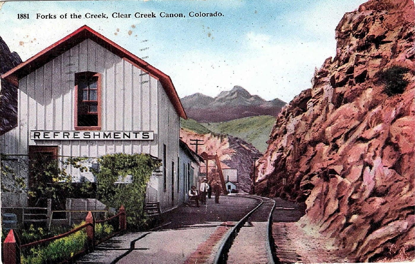 "Forks of the Creek" shows a white depot with "REFRESHMENTS" sign next to narrow gauge tracks.