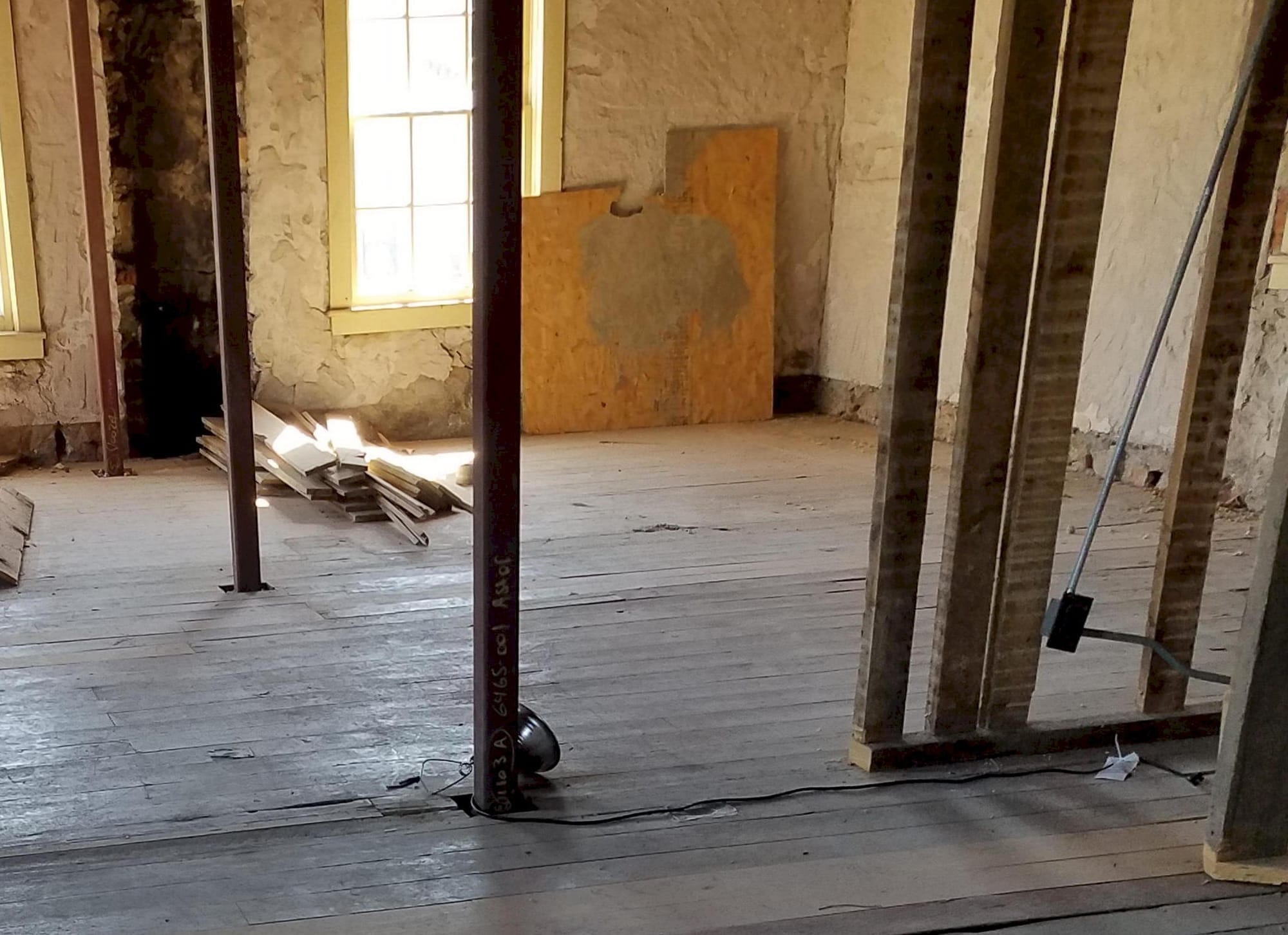 a few upright posts indicate where there used to be walls - rock exterior walls, board flooring