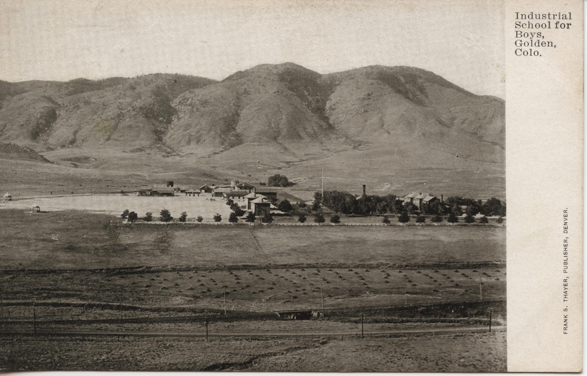 black & White postcard showing several two-story buildngs with a hay field in foreground, mountains in background black & White postcard showing several two-story buildngs with a hay field in foreground, mountains in background black & White postcard showing several two-story buildngs with a hay field in foreground, mountains in background black & White postcard showing several two-story buildngs with a hay field in foreground, mountains in background black & White postcard showing several two-story buildings with a hay field in foreground, mountains in background