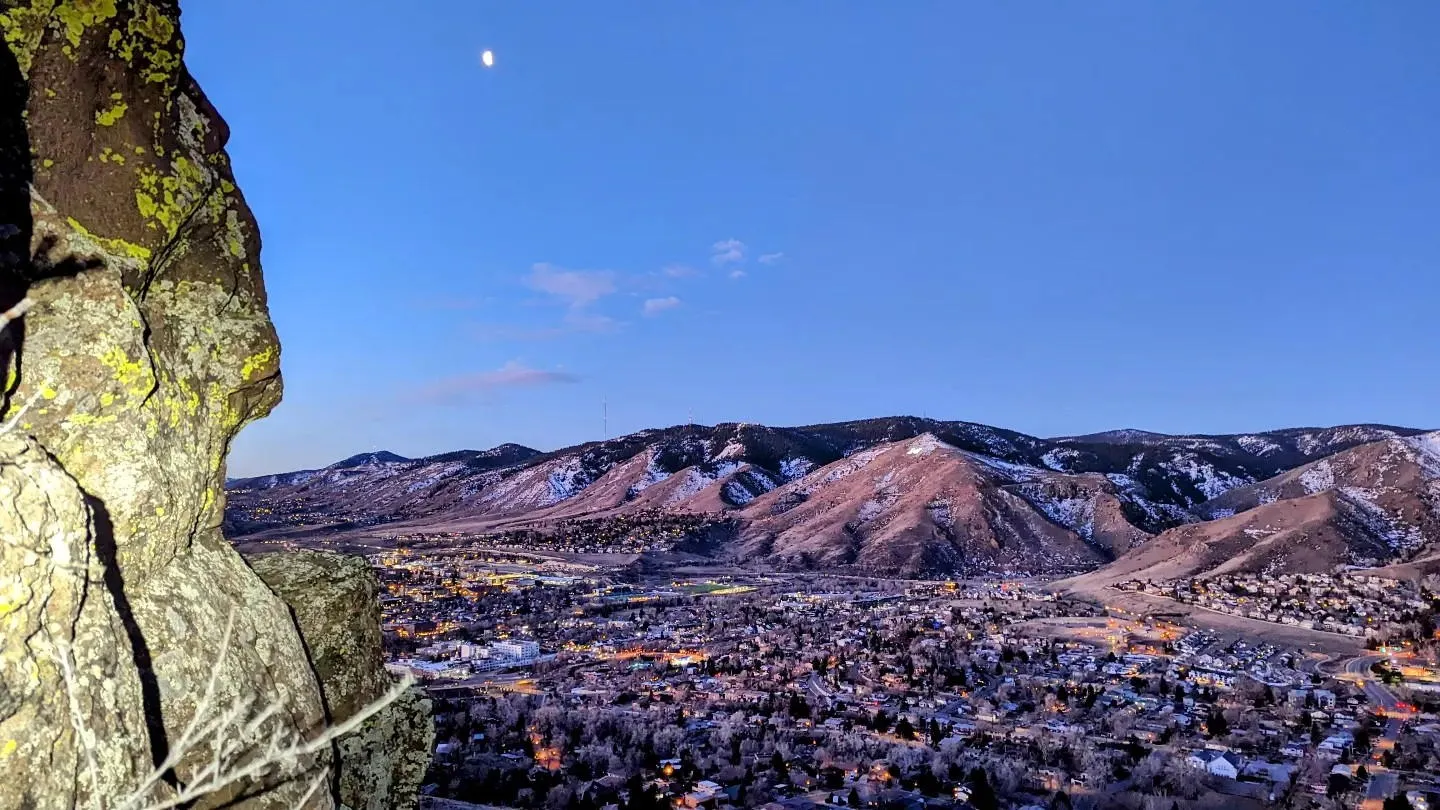 The foothills west of Golden with a light dusting of snow and the waning moon high in the sky.