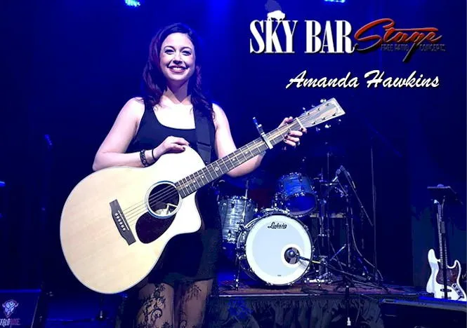 Image says "Sky Bar Stage - Amanda Hawkins" and shows a woman with guitar in front of a drum set