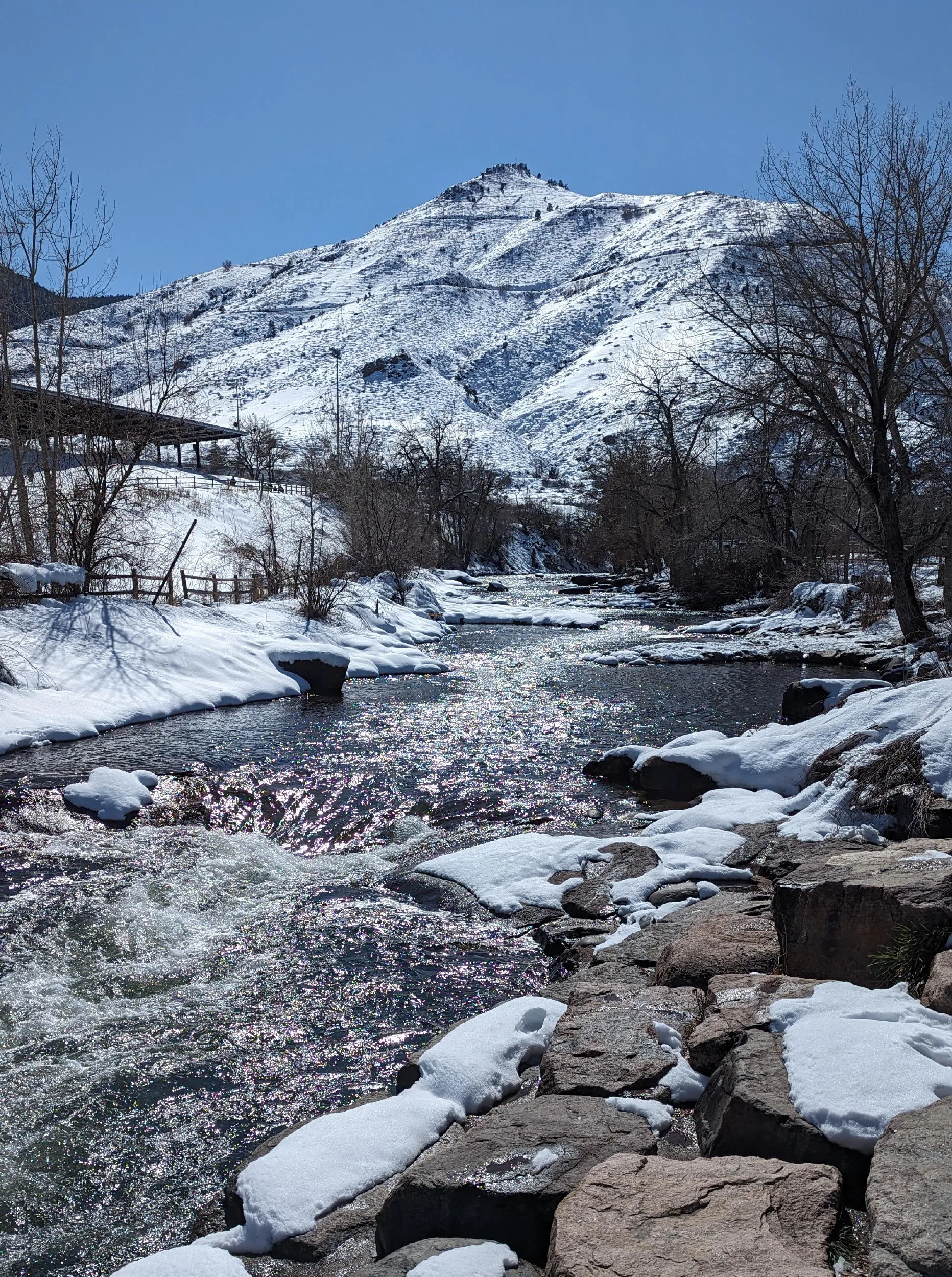 Winter view of Mt. Zion with Clear Creek in the foreground, snow on either side.