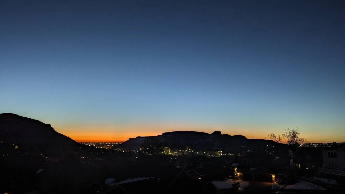 Light is appearing on the horizon as South Table Mountain shows in silhouette