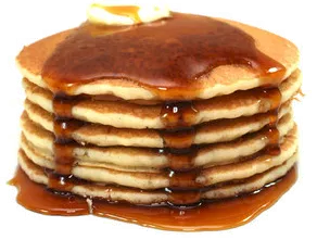 stack of pancakes, dripping with syrup and topped with a pat of butter