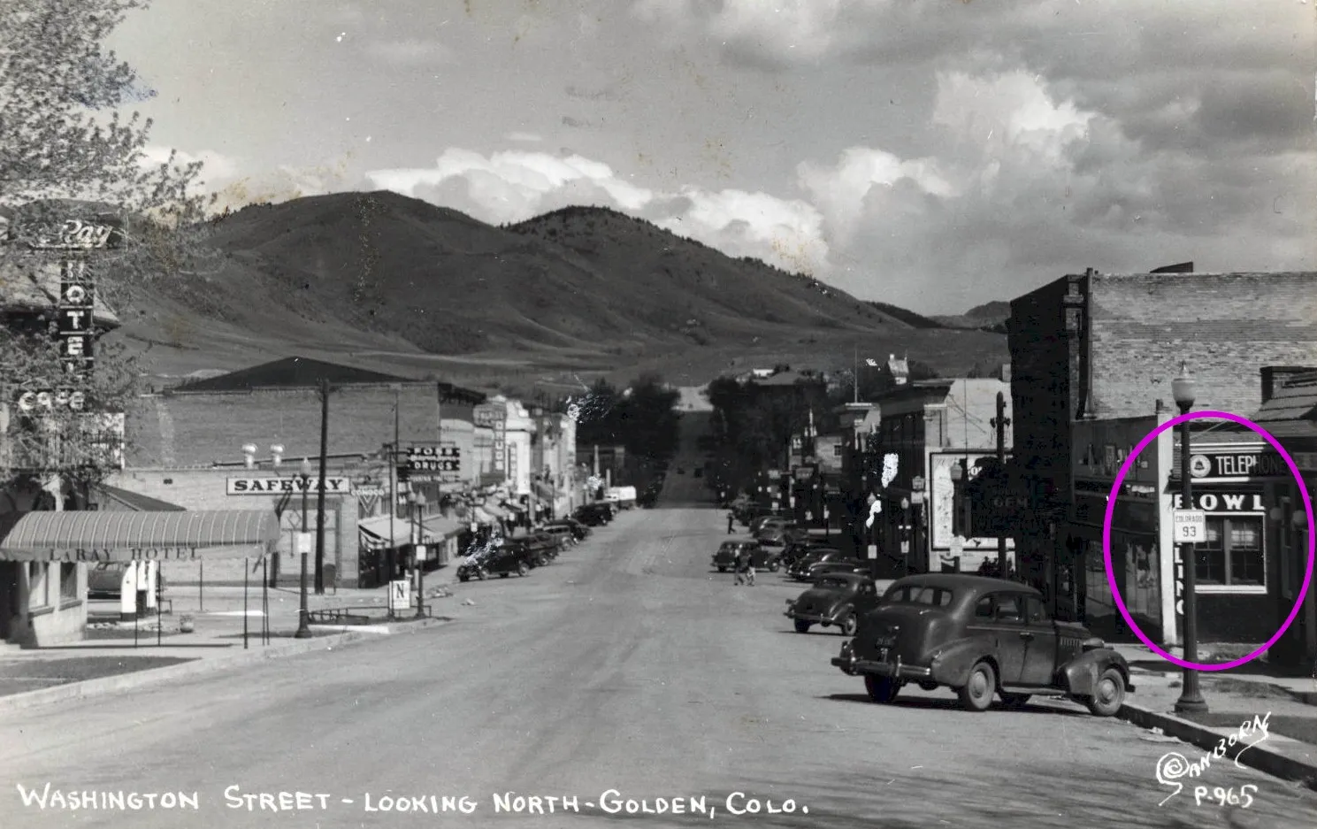 black & white postcard image of downtown Golden. LaRay Hotel on the left (now Table Mountain Inn) Sign on right says BOWL.