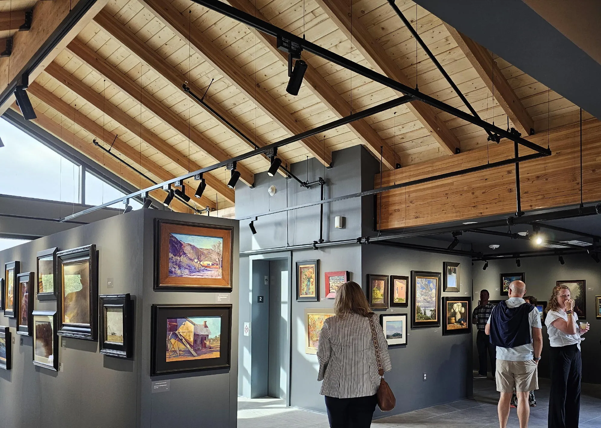 several people enjoying an art exhibition