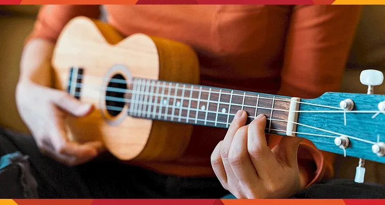 strumming a ukulele