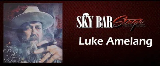 Luke Amelang at the Buffalo Rose - shows man in cowboy hat holding a smoking cigar