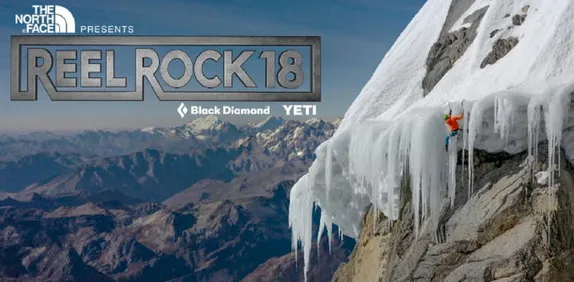 Tiny-looking climber on a steep ice overhang on an apparently tall mountain.  More ice-capped mountains in background.