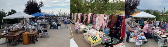 Booths with tables full of fabric and notions - quilts hanging on a rod