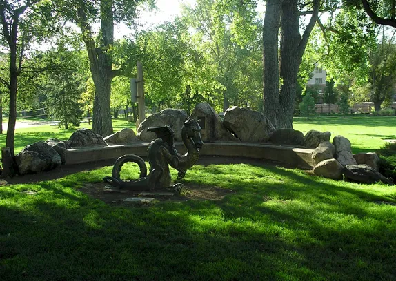 small bronze statue of a dragon in Parfet Park