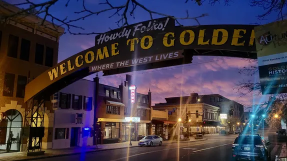 dark sky over the welcome arch with clouds just starting to turn pink